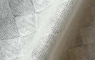 Diamond pattern viscose polyester spunlace nonwoven fabric with textured surface for improved cleaning performance