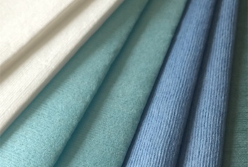 Colored woodpulp polyester spunlace nonwoven in blue, turquoise, and green for industrial wipes and cleaning applications