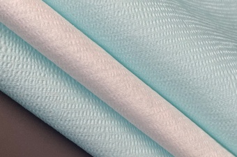Creped woodpulp polyester spunlace nonwoven fabric with textured surface for industrial wipes and automotive cleaning